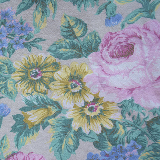 Upcycling cotton fabric with pink and yellow flowers on grey background